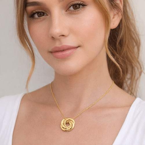 Mom wearing personalized kids names necklace in gold Mom necklace with kids names engraved on interlocking gold rings — personalized mother jewelry gift by Keevola