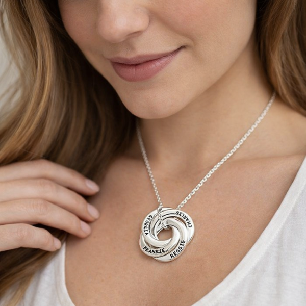 Mom wearing personalized kids names necklace in silver