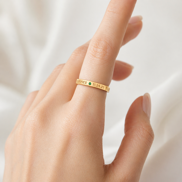 New mom wearing a personalized ring with baby name birthstone and birth stats