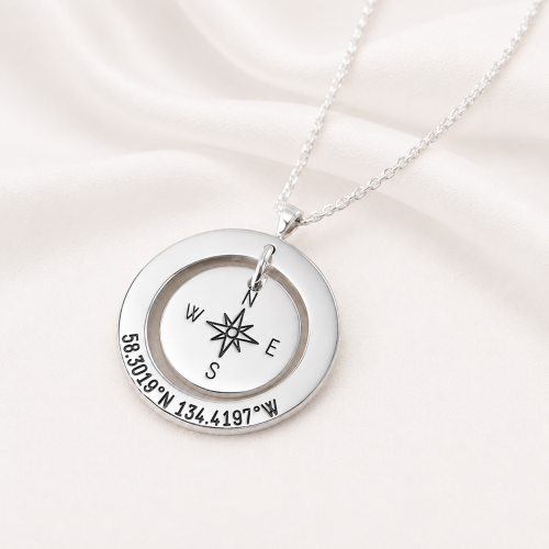 Compass Design Close-Up – GPS Coordinates Engraving Close-up of compass design with engraved GPS coordinates on personalized sterling silver necklace