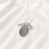 Personalized fingerprint pendant shown in silver with birthstone charm